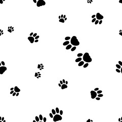 Fototapeta na wymiar Seamless vector pattern with footprint of cat`s paws. Black paws of cats and kittens on the white background. Seamless pattern with silhouettes of paws of pets. 