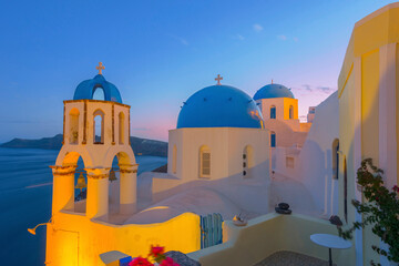 Naklejka premium Greece Santorini island in Cyclades, wide view of white washed colorful houses at night