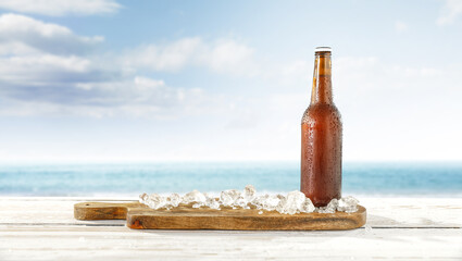 Summer beer on table and desk with ice. Sea landscape and free space for your decoration 