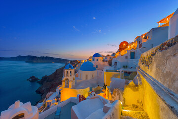 Greece Santorini island in Cyclades, wide view of white washed colorful houses at night