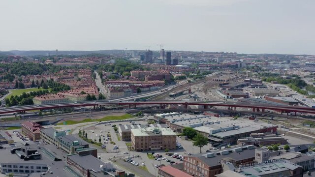 Busy interstate heavy traffic driving through freeway Gothenburg Sweden Scandinavian city population going to work transporting goods cars buses jam police tram people aerial Sverige drone wide view