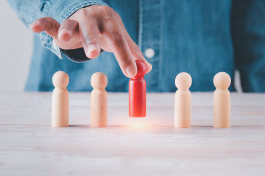 leadership business concept, leader teamwork power and confidence, hand holding leader to success business create idea, professional hand holding wooden figures selection leader  business conceptual.