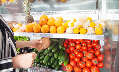 Woman buying coconut at food store.