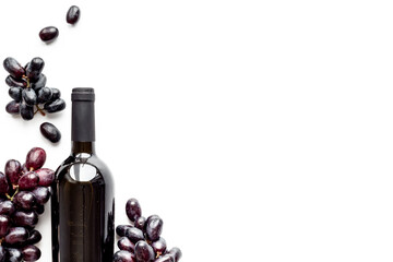 Bottle of red wine isolated and dark grape. Top view