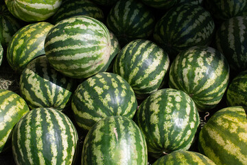 Pile of fresh watermelons for sale at a market
