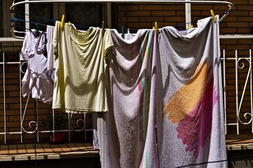 Clothes hung out to dry on lines outside the balcony (Marche, Italy, Europe)