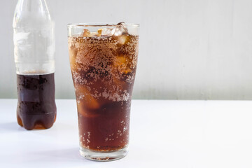 .Glass of soft drinks and black soft drinks on the table