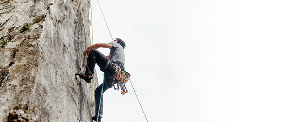 Rock climber climbing a vertical wall wall in the mountain. risk sport. mountain activity. image...