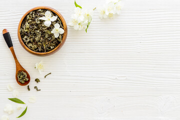 Jasmine flowers with dry tea in bowl. Top view