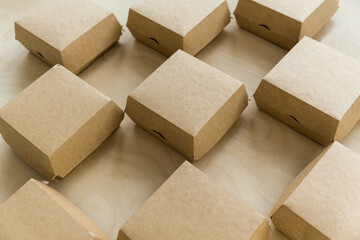 Closeup of kraft paper boxes for burgers on wooden background