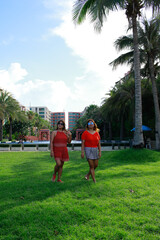 Obraz premium Portrait of twins asian young women at beautiful beach. Travel on vacation in summer season. Enjoy with lovely family holidays in tropical island.