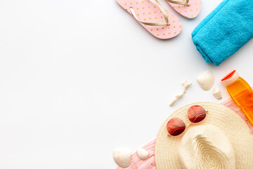 Flat lay of summer beach accessories isolated on white. Sraw hat with sunglasses and flip flops