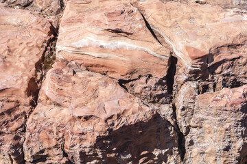 Unique colorful pattern of crumbling rock with deep cracks. Texture and natural background of sandstone.