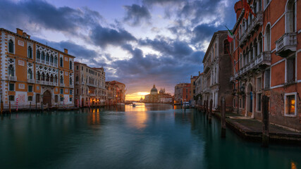 Fototapeta premium Grand Canal at sunrise in Venice, Italy. Sunrise view of Venice Grand Canal. Architecture and landmarks of Venice. Venice postcard