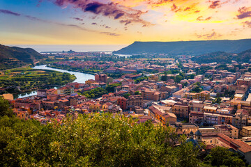 Fototapeta premium Beautiful view of Bosa town, Sardinia island, Italy. Travel destination. Bosa town with Ponte Vecchio bridge across the Temo river. Marvelous morning view of Sardinia island, Italy, Europe.