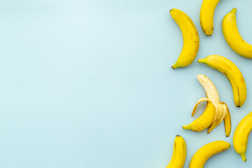 Obraz na płótnie Canvas Whole and peeled bananas flay lay. Fruits pattern. Top view