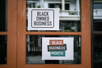 Black owned business and black business month sign were attached on the window