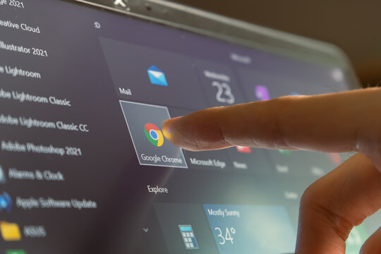 Bangkok, Thailand - June 23, 2021 : Computer user touching on Google Chrome, a web browser developed by Google, icon on Windows 10 to open the program.