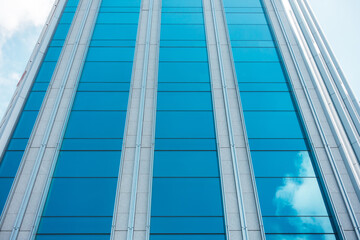 underside panoramic and perspective view to steel blue glass high rise building skyscrapers, business concept of successful industrial architecture