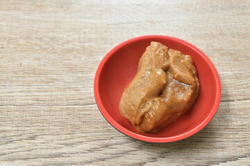 jaggery palm sugar in cup with silver spoon on table