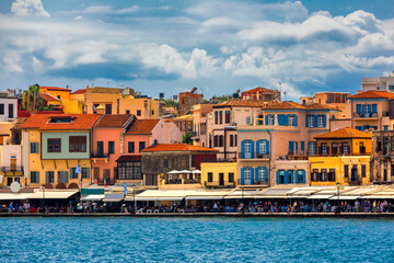 Obraz premium View of old port of Chania. Landmarks of Crete island. Greece. Bay of Chania at sunny summer day, Crete Greece. View of the old port of Chania, Crete, Greece. The port of chania, or Hania.