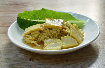 fried bean sprout with slice yellow tofu in plate on table