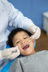 Asian kid check up with dentist at the dental clinic. Concept of dental check up and healthcare