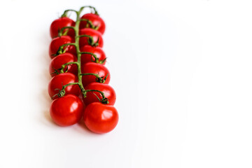 Fresh red delicious cherry tomatoes on white background. Summer agriculture. Italian cousine. Shallow depth of field selective focus creative image.