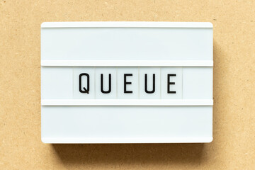 Lightbox with word queue on wood background