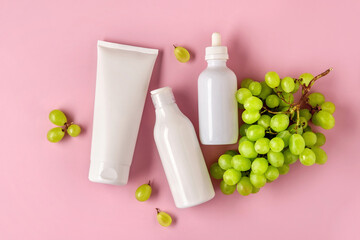 Three white mock up bottles for branding with grape seed oil. Skincare cosmetic product.