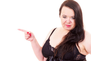 Naklejka premium Woman plus size in lingerie pointing at copy space