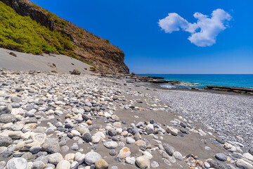 Sand dunes beneath high mountains east of Agia Roumeli on the south coast of the Greek island of...