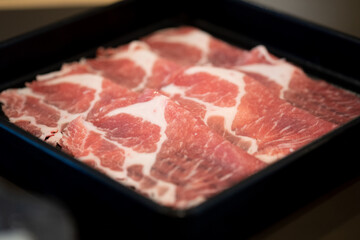 Close up of premium fresh sliced meat beef in black tray are prepared for cooking