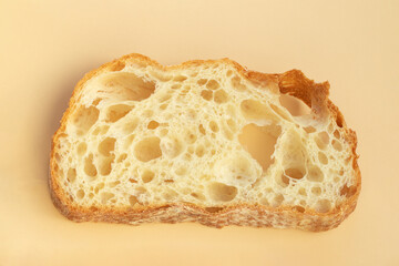 a piece of Italian ciabatta bread with yeast holes.