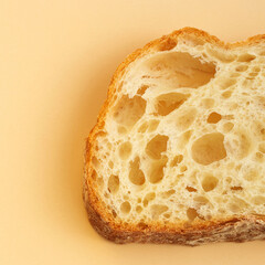 A slice of traditional Italian ciabatta bread with yeast holes