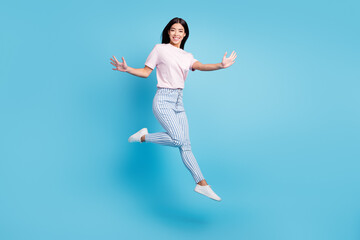 Fototapeta na wymiar Full body profile side photo of young asian girl happy positive smile have fun jump isolated over blue color background