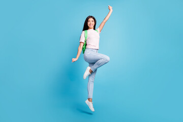 Fototapeta na wymiar Full length body size view of attractive cheerful teen girl jumping going to high school isolated over bright blue color background