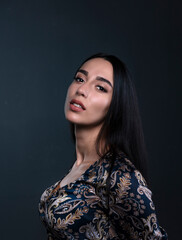 portrait of a young woman in the studio on a dark background