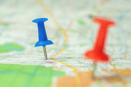 Destination background, city map with red and blue push pins, selective focus photo
