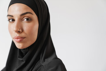 A close-up view of the muslim woman in hijab looking at the camera