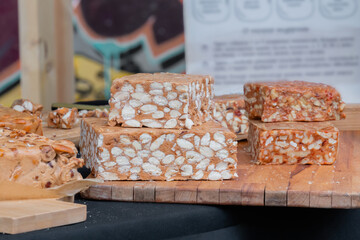 Sherbet with nuts and dried fruits on counter at summer local food market - close up view. Outdoor cooking, dessert, culinary, turkish sweet food, oriental and confectionery concept