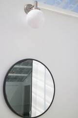 Black framed mirror on a white wall