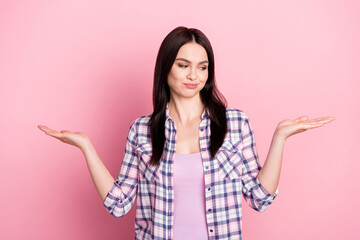 Portrait of attractive minded cheerful girl holding on palms copy empty space choosing isolated...