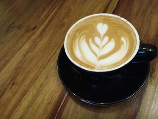 cup of coffee on wooden table