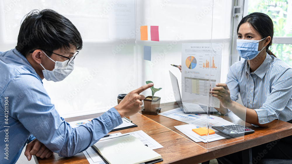 Aufkleber Two business colleagues showing and pointing on financial document for discussion in new business