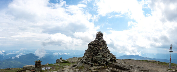 Fototapeta premium A pile of stones on a mountain top in the carpathian mountains in summer