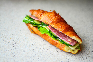 Delicious croissant with butter and salad