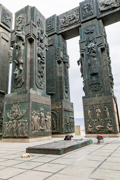 Contruction works in tourist attraction point - Chronicles of Georgia with dog laying in the middle surounded by giant columns. 13.03.2020.