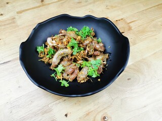 fried pork intestine with garlic in a black plate