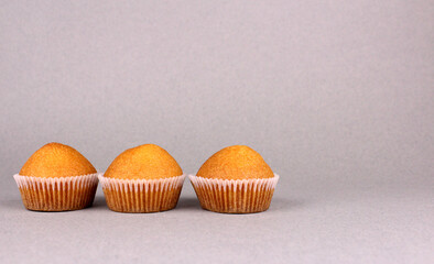 Three cupcakes on a gray background